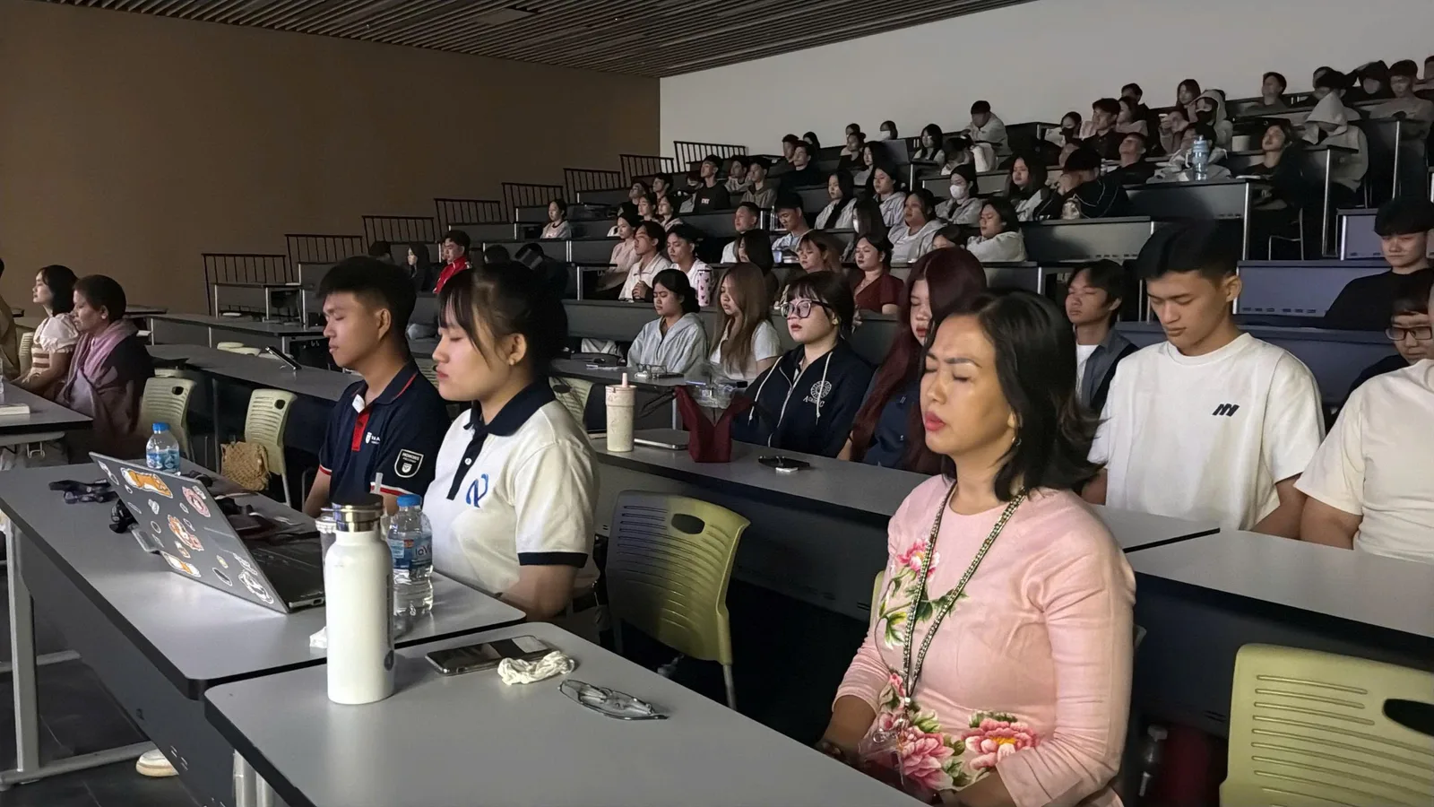 Students sitting still and observing their breath during the practice