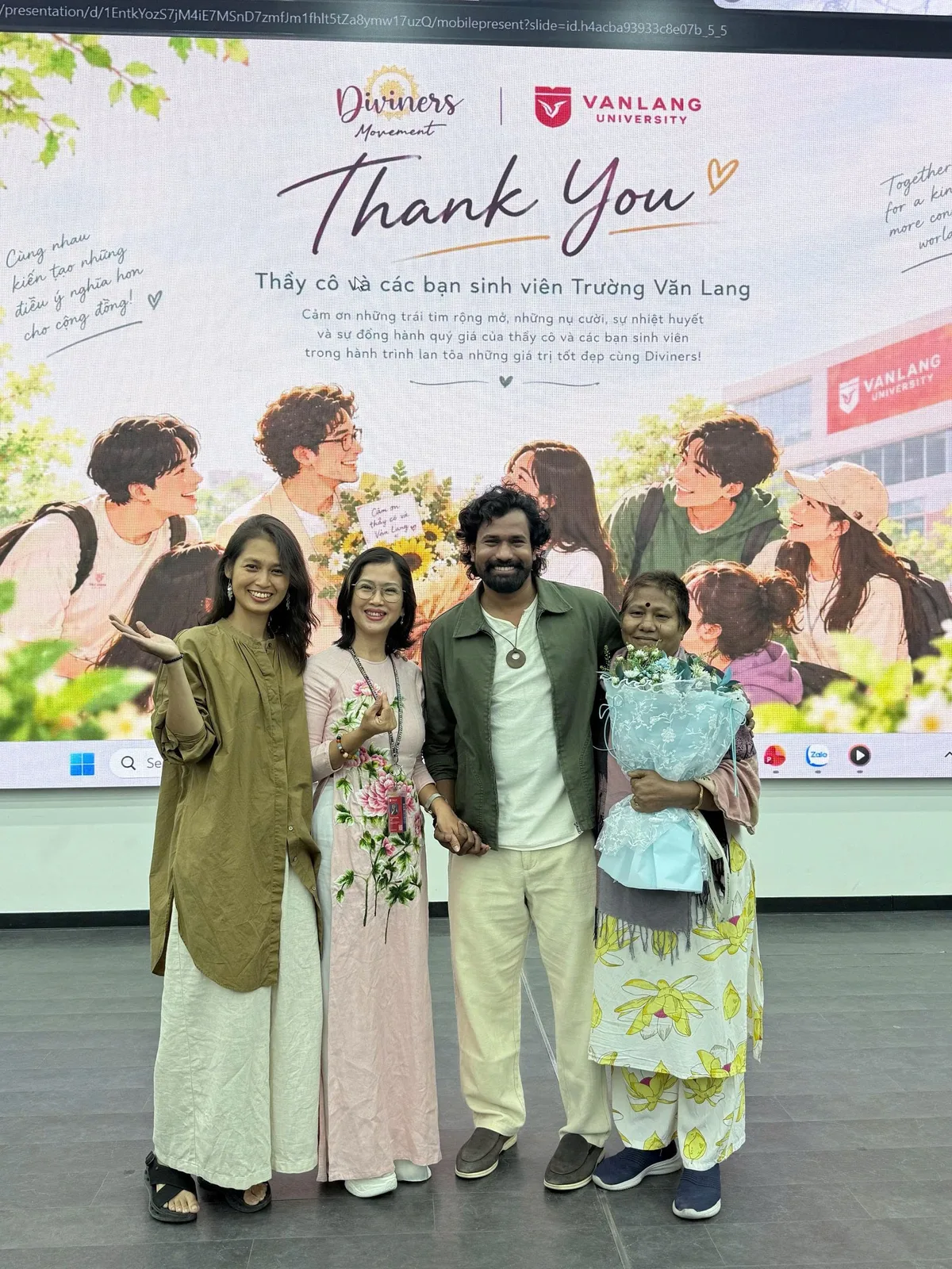 Master Oneness and companions posing in front of the thank-you board for Van Lang University